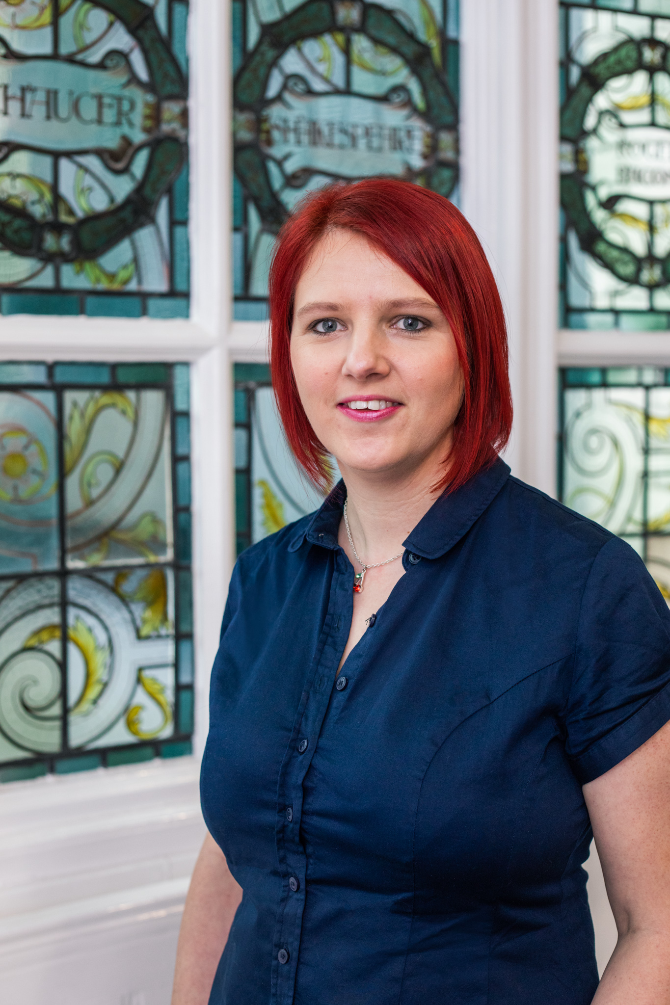 Claire Cronshaw Cherry Edits standing in front of a stained glass window