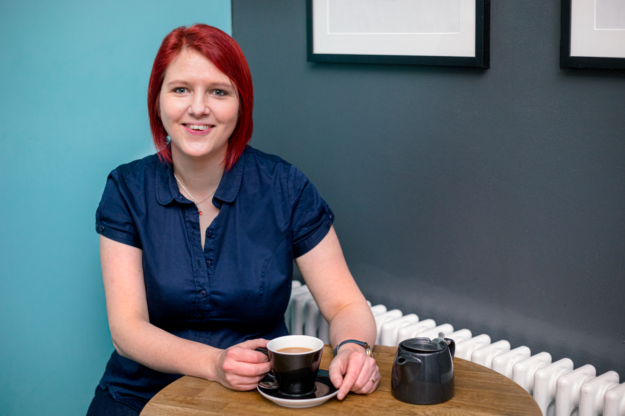 Claire Cronshaw Cherry Edits smiling at the camera with a cup of tea in hand